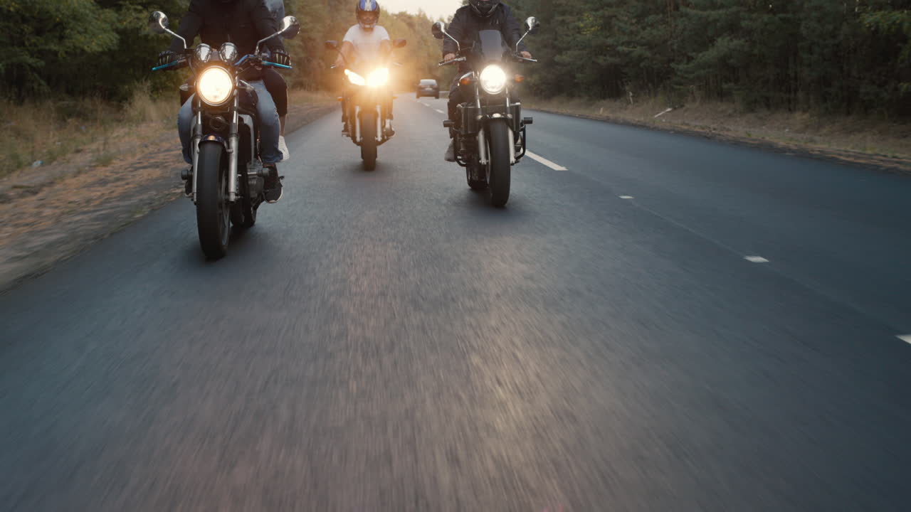 Premium stock video A group of bikers rides along the highway in a row