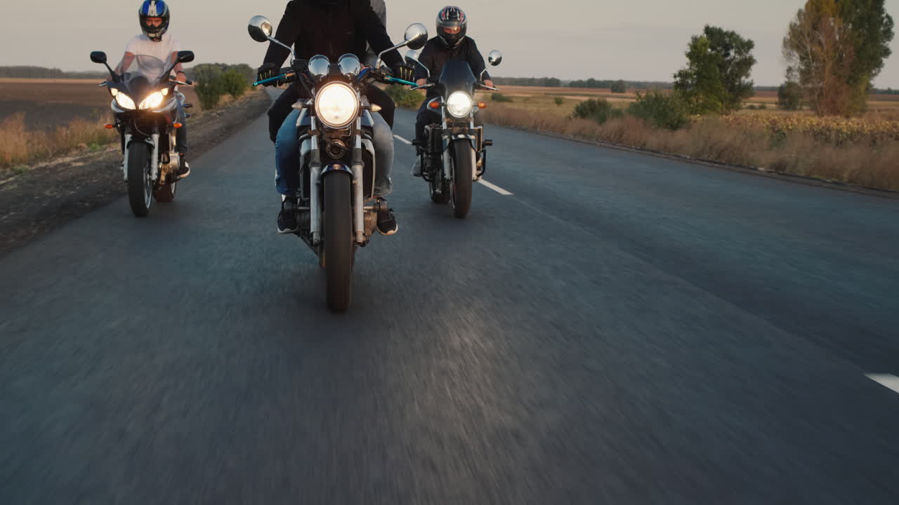 Premium stock video A group of bikers rides along the highway in a row 4