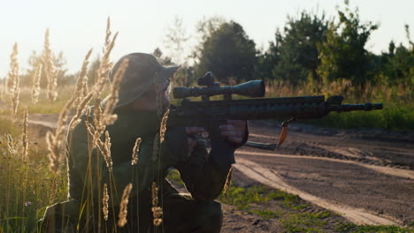 Premium Photo  Camouflaged sniper in the forest in ambush. military man  aiming a gun, a rifle at the enemy in nature