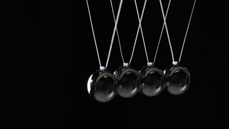 Balls-In-Newton's-Cradle-Hit-Each-Other-Demonstrating-Energy-Conservation-Law-1