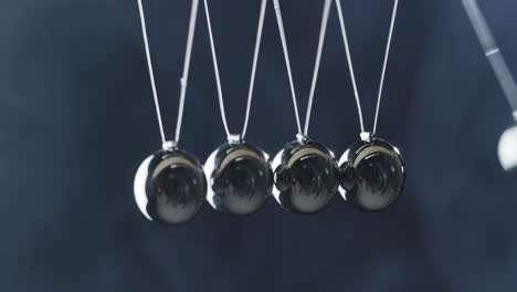 Close-Up-Of-Newton's-Cradle---Metal-Balls-Hit-One-Another-And-Show-Energy-Conservation-Effect