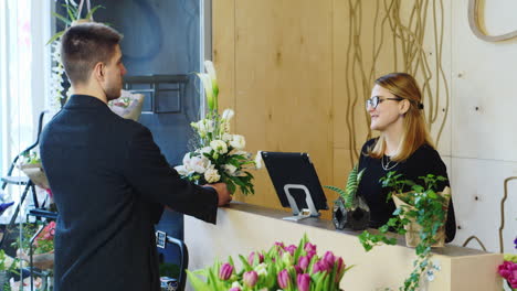 A-young-businessman-buys-a-bouquet-in-a-flower-shop-1