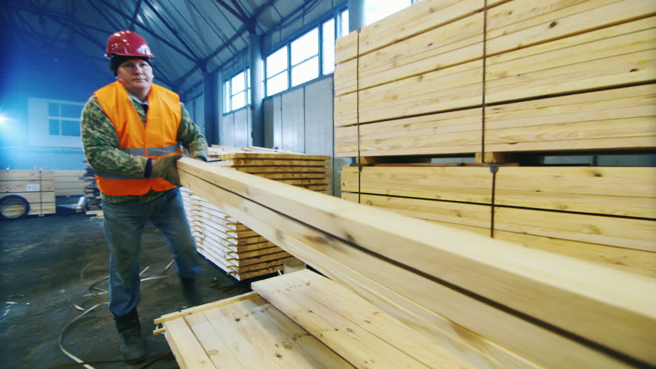 Premium stock video A group of workers moves wood slats in stock 1