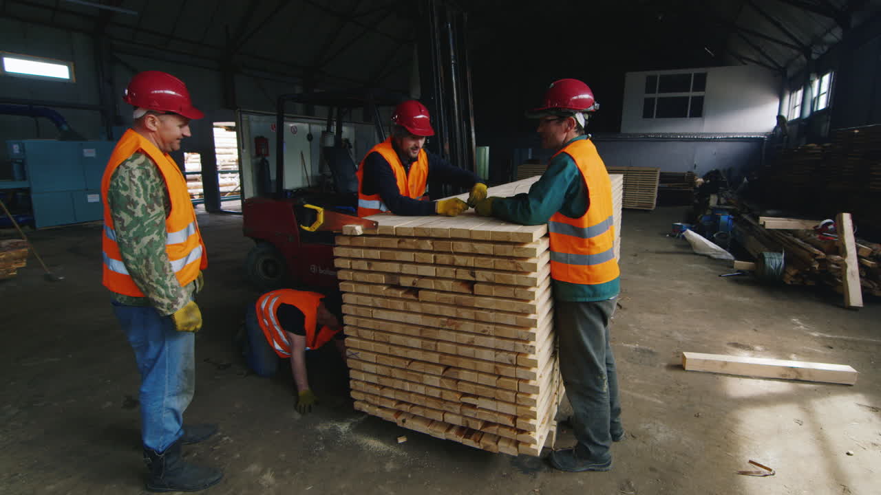 Premium stock video A group of workers moves wood slats in stock 5