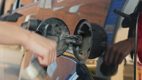 Hand-Holding-Refueling-Nozzle-Filling-Car