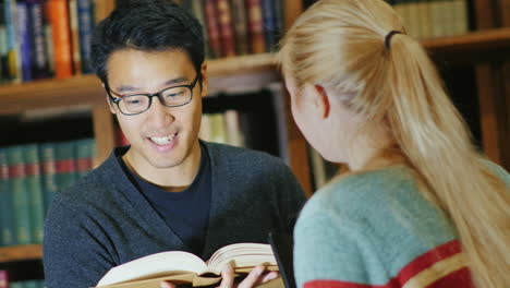 Smiling-Korean-Man-Talking-To-A-Woman-In-The-Library-2