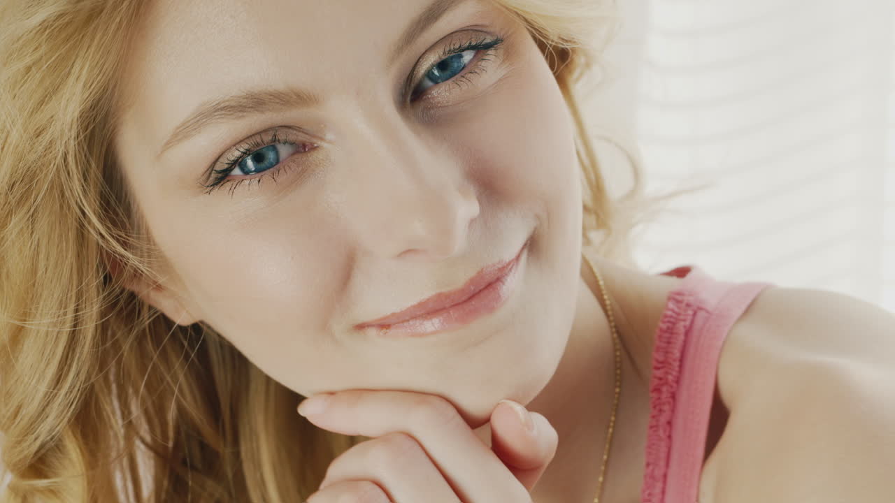 Premium stock video - Blue eyes of a young woman looking into the camera 2