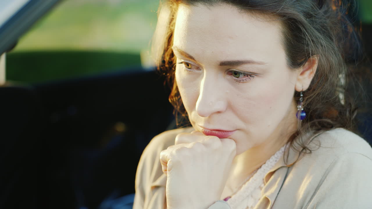 Premium stock video - Portrait of caucasian woman crying in car