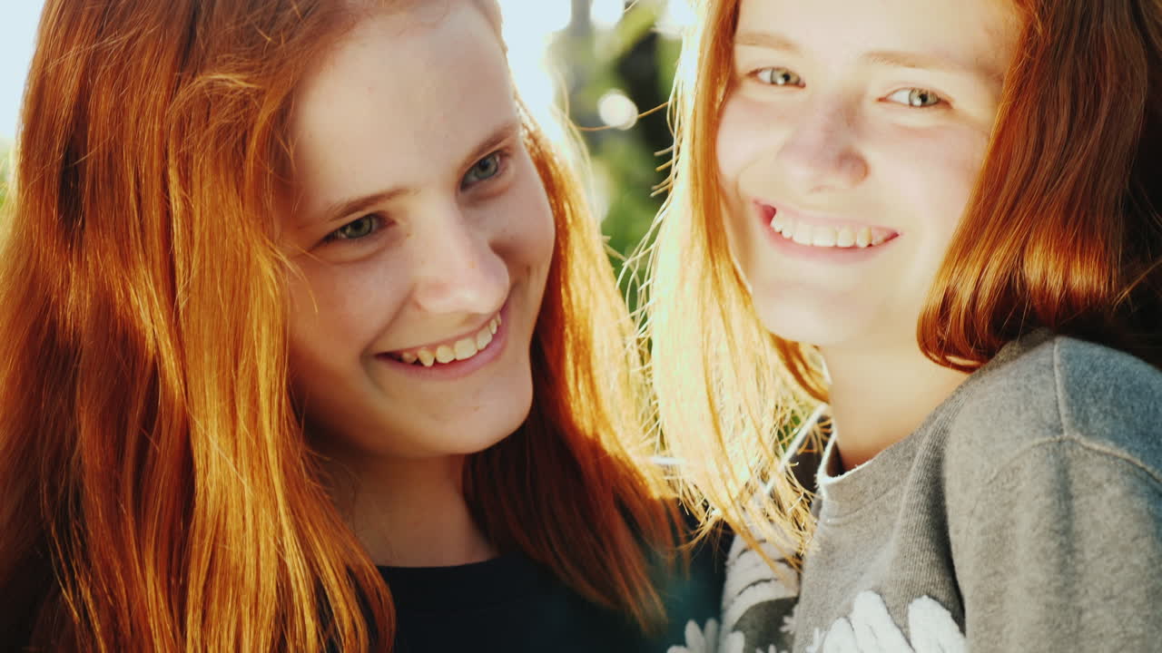 Premium stock video - Portrait of happy twin sisters