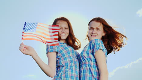 Portrait-Of-Twin-Girls-With-American-Flag