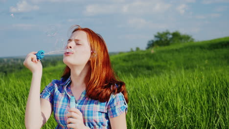 Red-Haired-Teen-Girl-Playing-With-Soap-Bubbles