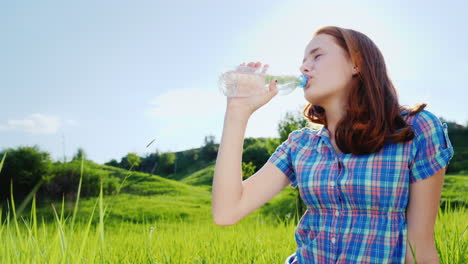 A-Teenager-Drinks-Clean-Water-From-A-Bottle-On-A-Picnic-In-A-Picturesque-Place-1
