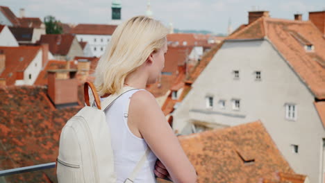 A-Young-Woman-Tourist-Is-Admiring-The-Old-European-City-From-A-Height