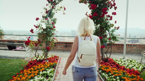 Back-View:-A-Young-Woman-Is-Walking-In-The-Garden-Of-Roses