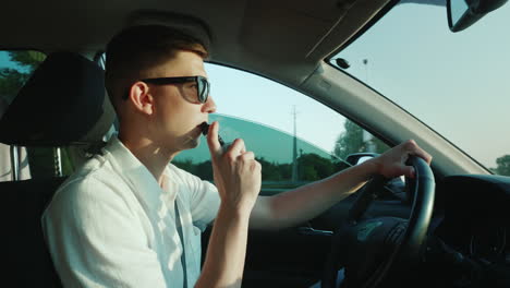 A-Young-Driver-Smokes-An-Electronic-Cigarette-While-Driving
