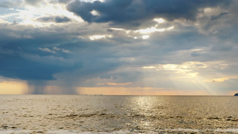 Strong-Rain-Far-Into-The-Sea-And-The-Setting-Sun-With-Beautiful-Rays-1