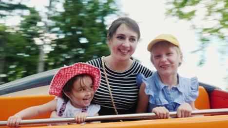Happy-Young-Mother-With-Two-Daughters-Riding-On-A-Swing-In-The-Park-1
