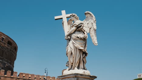 Steadicam-Shot:-Statue-Of-An-Angel-With-A-Cross-On-Background-Castel-Santangelo-And-Flag-Of-The-European-Union