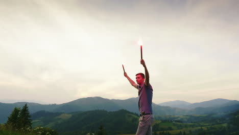 A-Man-In-The-Mountains-Signals-With-Hand-Fireworks-Looks-Up-1
