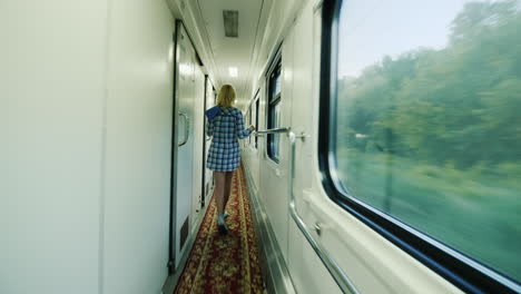 A-Woman-With-A-Towel-Is-Walking-Along-The-Carriage-Of-A-Passenger-Train-2