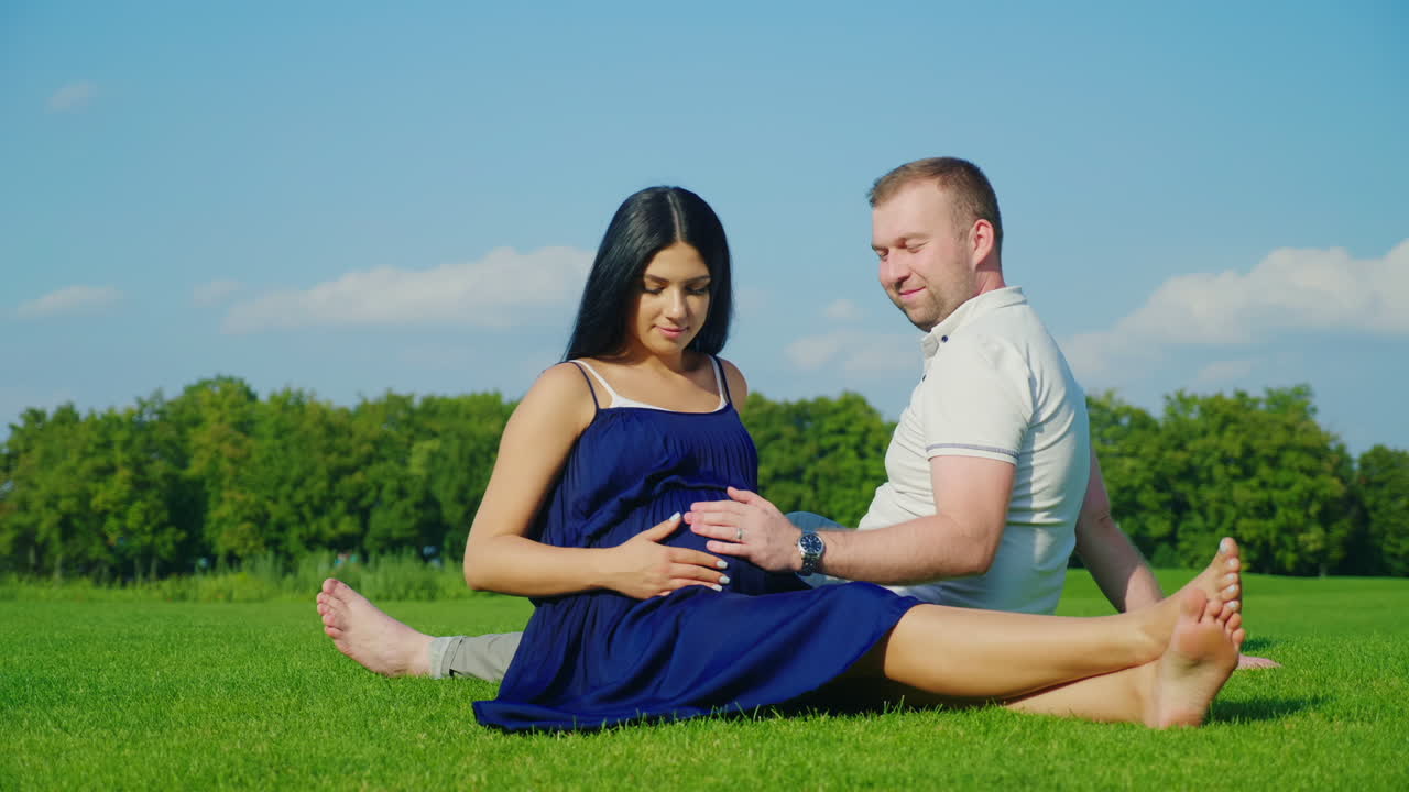 premium-stock-video-a-pregnant-woman-with-her-husband-considered-toys